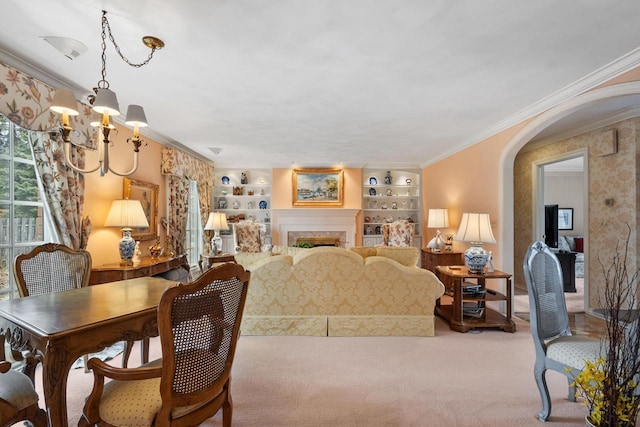 1012 E Kramer Ln, Appleton, WI 54915 - living room featuring an inviting chandelier, a fireplace, crown molding, arched walkways, and light colored carpet