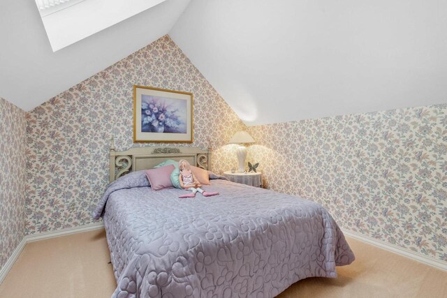 1012 E Kramer Ln, Appleton, WI 54915 - bedroom with vaulted ceiling with skylight, wallpapered walls, baseboards, and carpet floors