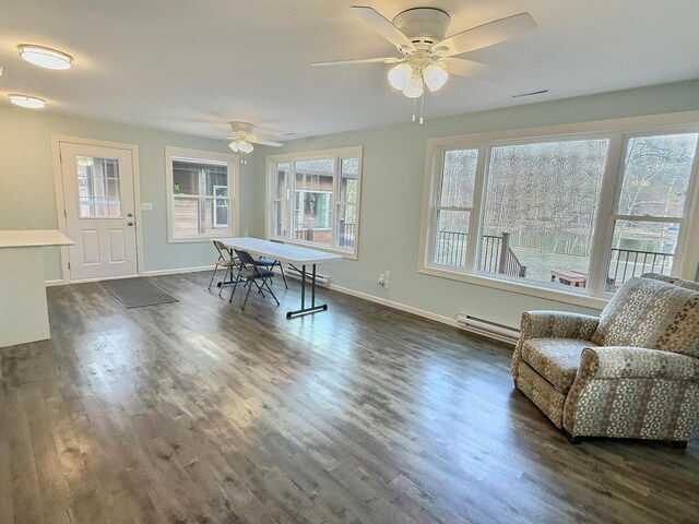 N9378 21st Ave, Neshkoro, WI 54960 - dining area with dark wood-style floors, baseboard heating, baseboards, and ceiling fan