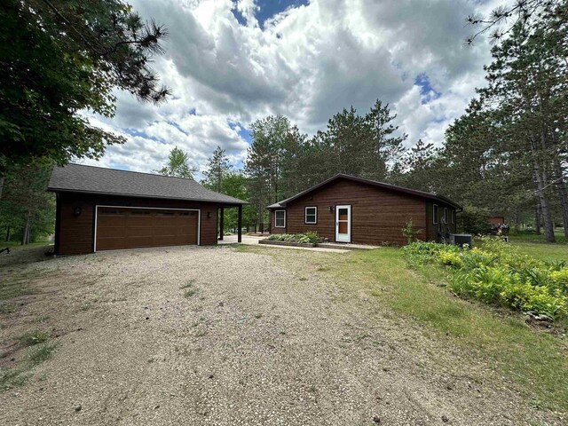 N9378 21st Ave, Neshkoro, WI 54960 - view of side of property with an outbuilding, a garage, and gravel driveway