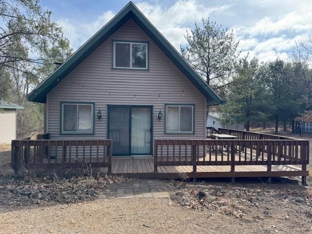 rear view of property with a wooden deck