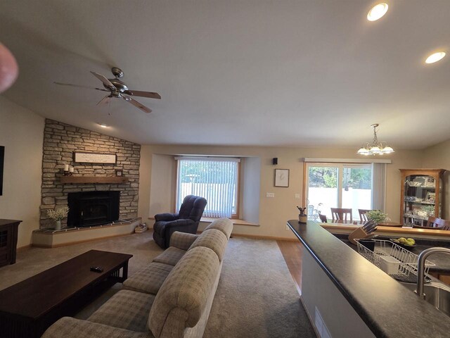 246 Golliher Ct, Westfield, WI 53964 - living room with ceiling fan with notable chandelier, carpet flooring, vaulted ceiling, and a wealth of natural light