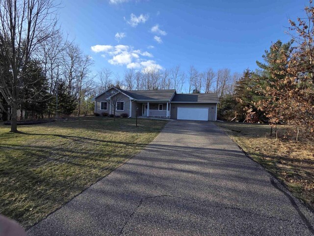246 Golliher Ct, Westfield, WI 53964 - single story home featuring a porch, driveway, a garage, and a front lawn