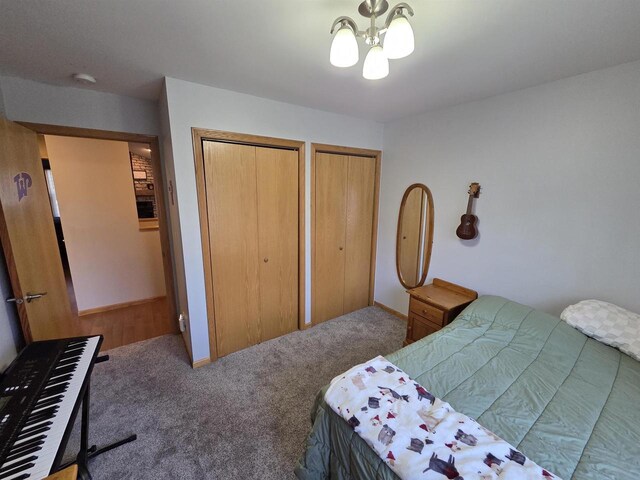 246 Golliher Ct, Westfield, WI 53964 - bedroom featuring carpet floors, a notable chandelier, and multiple closets