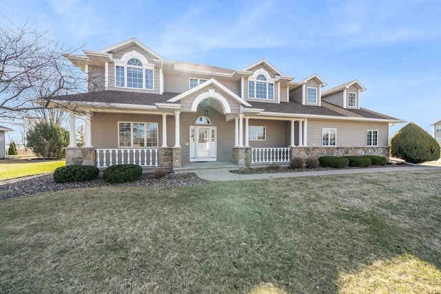 3895 Shorebird Ct, Oshkosh, WI 54904 - view of front facade featuring a front yard, stone siding, covered porch, and roof with shingles