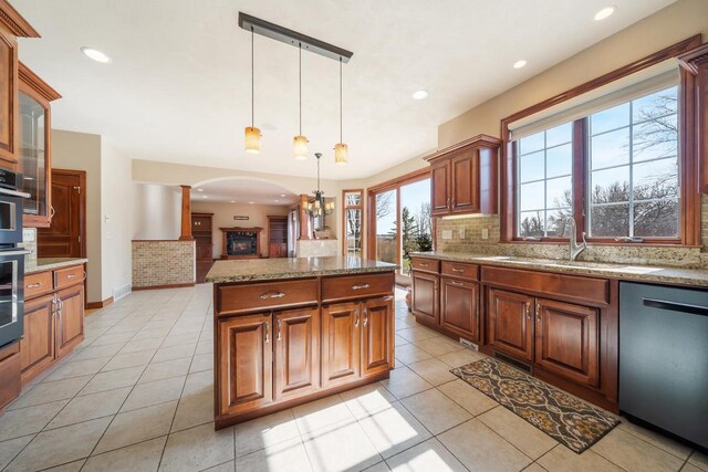3895 Shorebird Ct, Oshkosh, WI 54904 - kitchen with light tile patterned flooring, dishwasher, a sink, and decorative backsplash