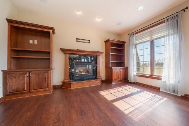 3895 Shorebird Ct, Oshkosh, WI 54904 - unfurnished living room with recessed lighting, a high end fireplace, dark wood-style floors, and baseboards