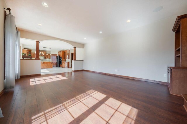 3895 Shorebird Ct, Oshkosh, WI 54904 - unfurnished living room with decorative columns, arched walkways, recessed lighting, and wood finished floors