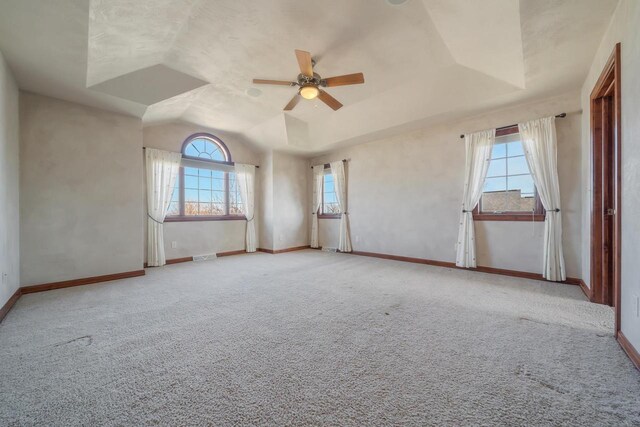 3895 Shorebird Ct, Oshkosh, WI 54904 - empty room with carpet floors, a tray ceiling, baseboards, and ceiling fan