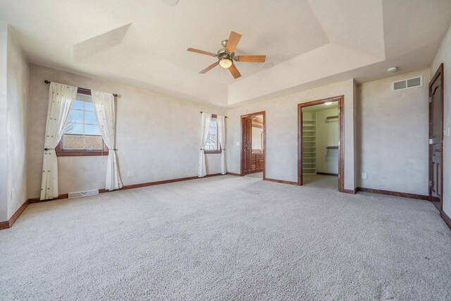 3895 Shorebird Ct, Oshkosh, WI 54904 - unfurnished bedroom with a tray ceiling, multiple windows, and visible vents