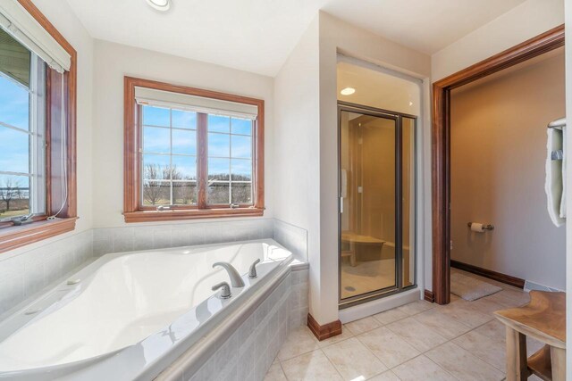 3895 Shorebird Ct, Oshkosh, WI 54904 - bathroom with a shower stall, a garden tub, baseboards, and tile patterned flooring