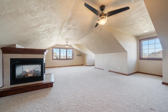 3895 Shorebird Ct, Oshkosh, WI 54904 - additional living space with ceiling fan, a textured ceiling, carpet floors, lofted ceiling, and baseboards
