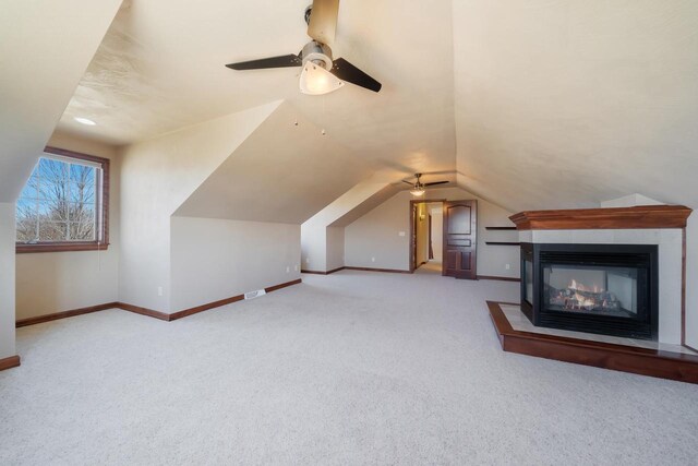 3895 Shorebird Ct, Oshkosh, WI 54904 - bonus room with baseboards, vaulted ceiling, a multi sided fireplace, carpet floors, and ceiling fan