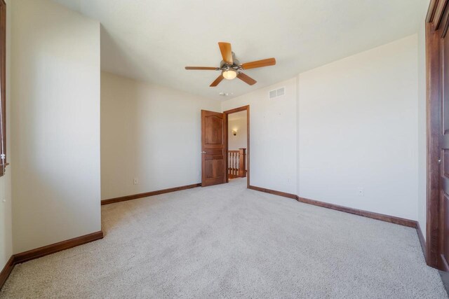 3895 Shorebird Ct, Oshkosh, WI 54904 - empty room featuring light colored carpet, ceiling fan, baseboards, and visible vents