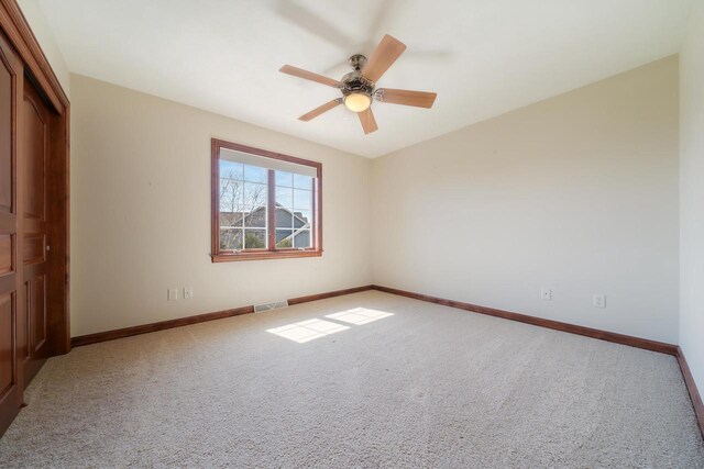 3895 Shorebird Ct, Oshkosh, WI 54904 - unfurnished bedroom featuring visible vents, baseboards, ceiling fan, and carpet floors