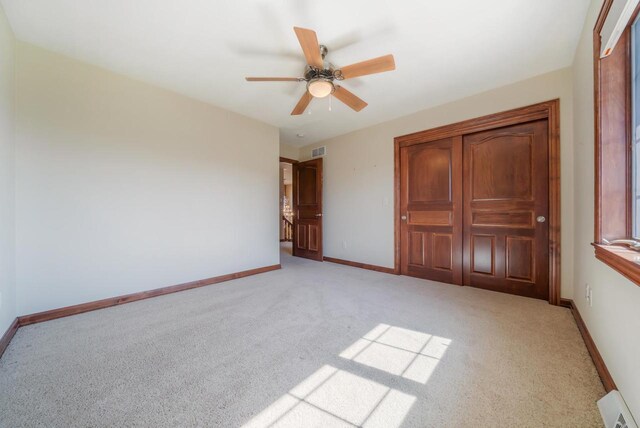 3895 Shorebird Ct, Oshkosh, WI 54904 - unfurnished bedroom featuring light colored carpet, baseboards, a ceiling fan, and visible vents