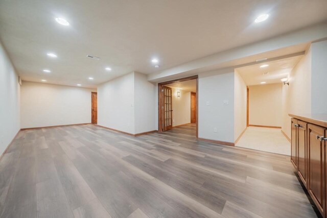 3895 Shorebird Ct, Oshkosh, WI 54904 - finished below grade area featuring visible vents, baseboards, light wood-type flooring, and recessed lighting