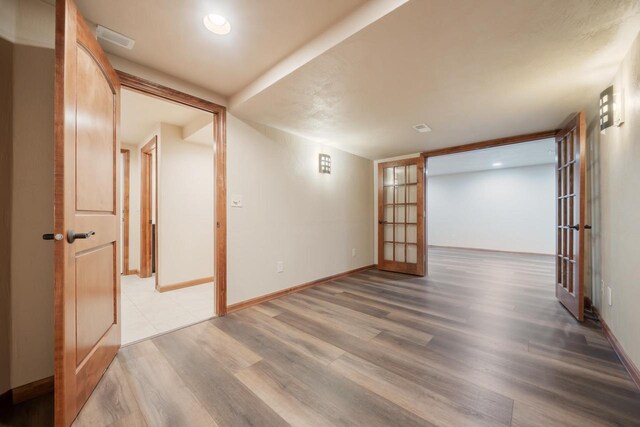 3895 Shorebird Ct, Oshkosh, WI 54904 - spare room with french doors, wood finished floors, baseboards, and visible vents