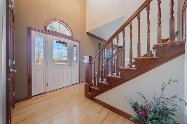 3895 Shorebird Ct, Oshkosh, WI 54904 - entryway with a towering ceiling, wood finished floors, baseboards, and stairway