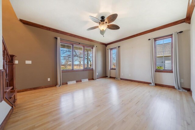 3895 Shorebird Ct, Oshkosh, WI 54904 - empty room with light wood-style floors, a ceiling fan, and a healthy amount of sunlight