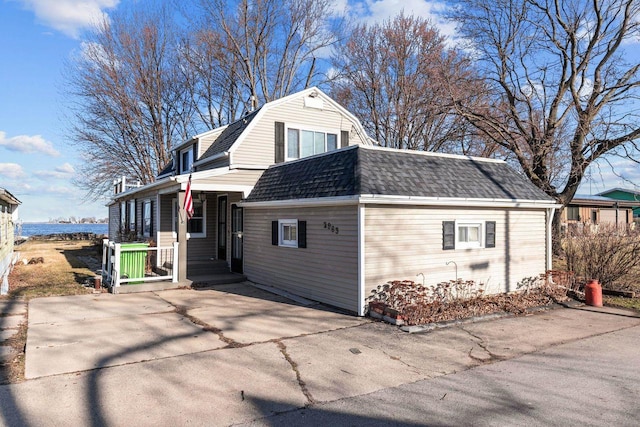2963 Sunset Point Ln, Oshkosh, WI 54904 - exterior space featuring a gambrel roof, a shingled roof, and covered porch