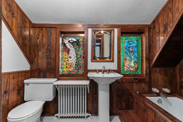 2963 Sunset Point Ln, Oshkosh, WI 54904 - full bath featuring a textured ceiling, radiator heating unit, toilet, wood walls, and a bathtub