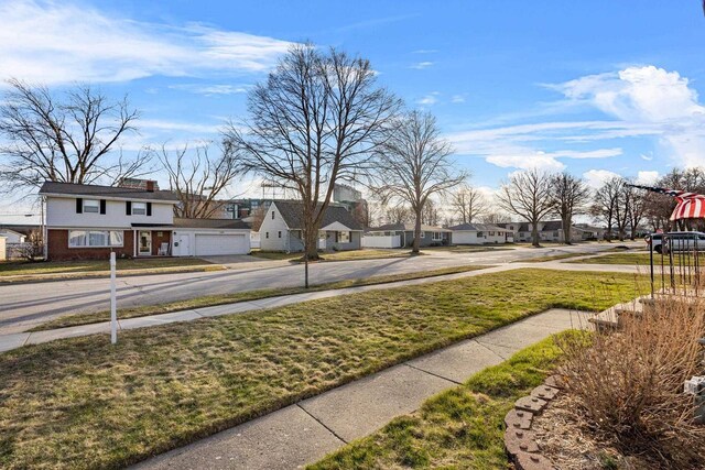 1210 Thorndale St, Green Bay, WI 54304 - view of yard with concrete driveway, a garage, and a residential view