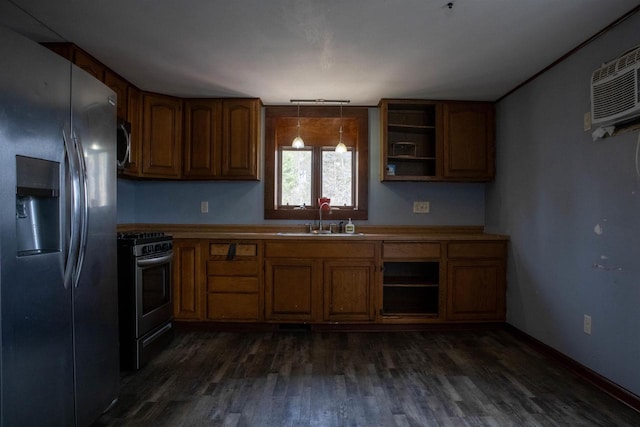2940 Plover Springs Dr, Plover, WI 54467 - kitchen with stainless steel appliances, brown cabinetry, a sink, and dark wood finished floors
