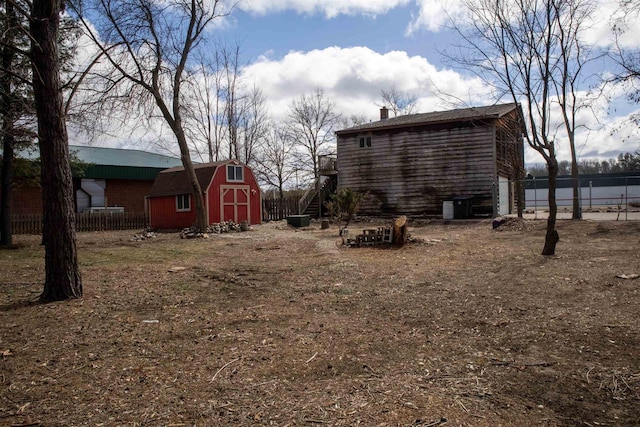 2940 Plover Springs Dr, Plover, WI 54467 - view of yard featuring fence, an outdoor structure, an attached garage, and a storage unit