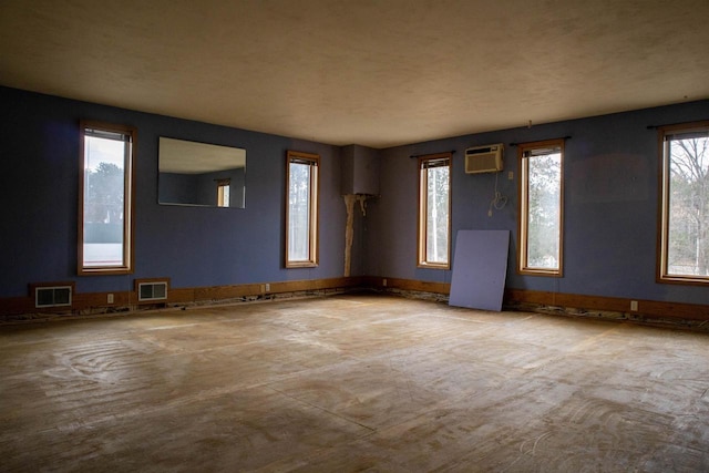 2940 Plover Springs Dr, Plover, WI 54467 - spare room featuring visible vents and an AC wall unit