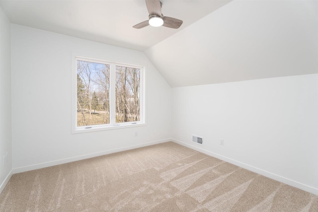 additional living space with visible vents, baseboards, a ceiling fan, carpet, and lofted ceiling