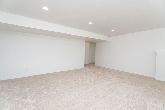 unfurnished room featuring recessed lighting, baseboards, and light colored carpet