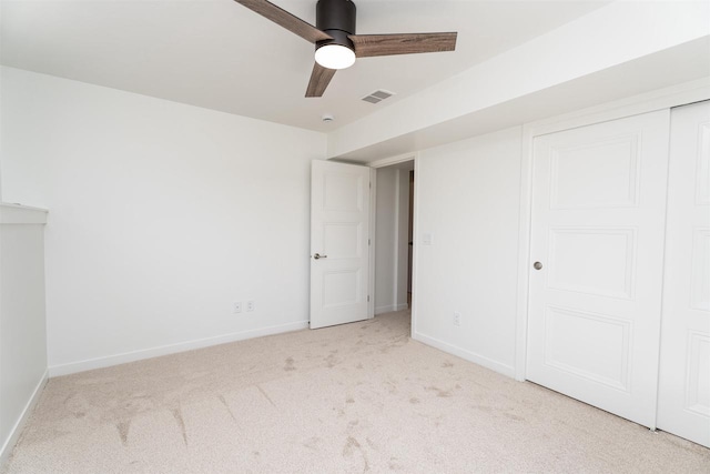 unfurnished bedroom featuring ceiling fan, carpet, a closet, visible vents, and baseboards
