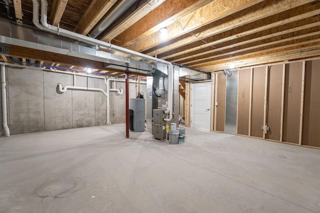 unfinished below grade area with heating unit and gas water heater