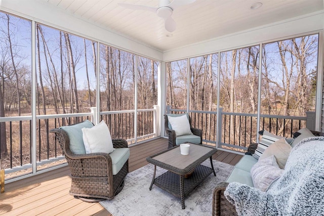 sunroom with ceiling fan and an outdoor living space