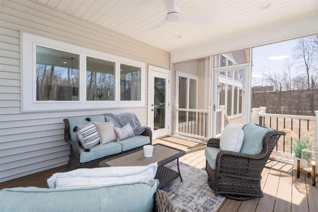 sunroom featuring a ceiling fan and an outdoor hangout area