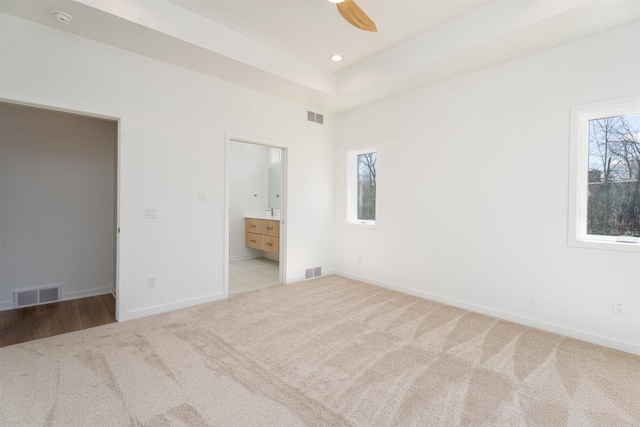 unfurnished bedroom with multiple windows and visible vents