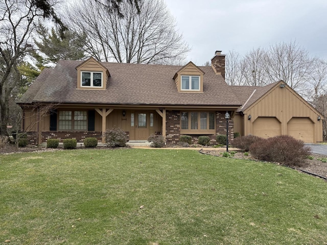 new england style home featuring roof with shingles, a chimney, an attached garage, a front yard, and brick siding