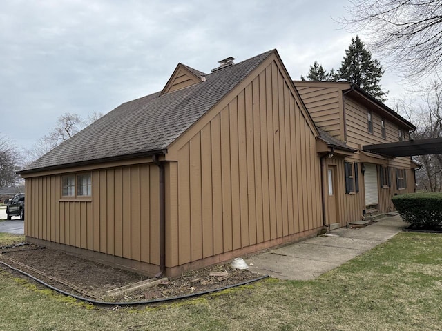 view of side of home with roof with shingles and board and batten siding