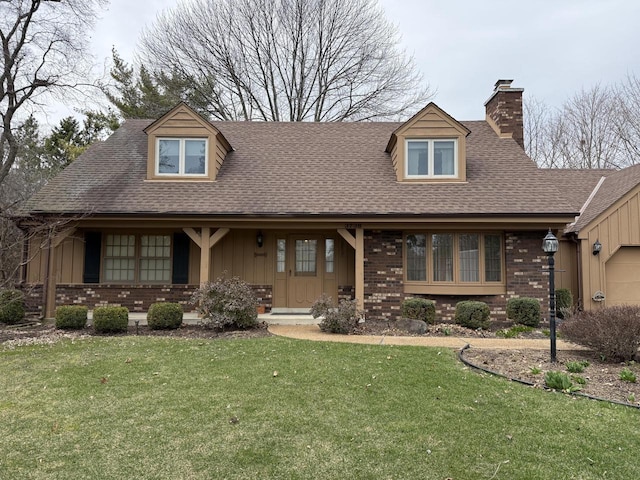 new england style home featuring a chimney, board and batten siding, brick siding, a front lawn, and roof with shingles