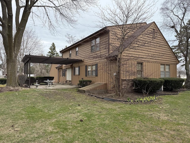 rear view of property featuring a yard and a patio