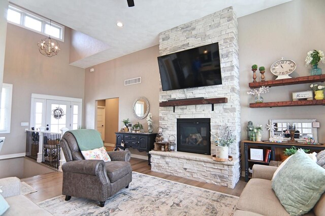 1817 Arboretum Dr, Janesville, WI 53548 - living area with visible vents, a notable chandelier, wood finished floors, and a fireplace