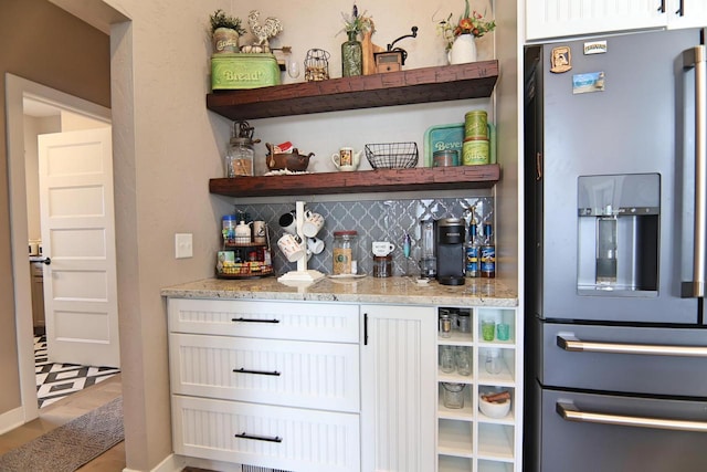 1817 Arboretum Dr, Janesville, WI 53548 - bar with bar area, decorative backsplash, and stainless steel fridge