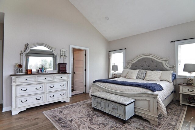 1817 Arboretum Dr, Janesville, WI 53548 - bedroom with dark wood-type flooring, high vaulted ceiling, and multiple windows