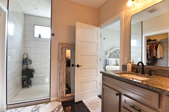 1817 Arboretum Dr, Janesville, WI 53548 - ensuite bathroom with vanity, a spacious closet, connected bathroom, tiled shower, and visible vents