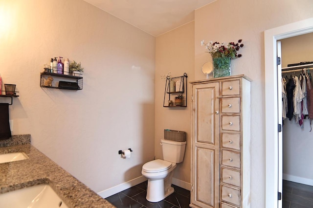 1817 Arboretum Dr, Janesville, WI 53548 - bathroom with tile patterned flooring, baseboards, toilet, and a walk in closet