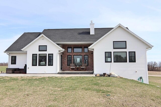1817 Arboretum Dr, Janesville, WI 53548 - back of house featuring roof with shingles, a chimney, and a lawn