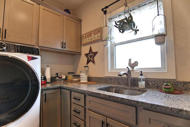 1817 Arboretum Dr, Janesville, WI 53548 - laundry room with cabinet space, washer / dryer, a textured wall, and a sink