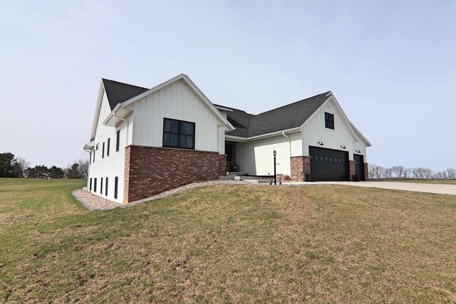 1817 Arboretum Dr, Janesville, WI 53548 - modern farmhouse with concrete driveway, a front yard, brick siding, and board and batten siding