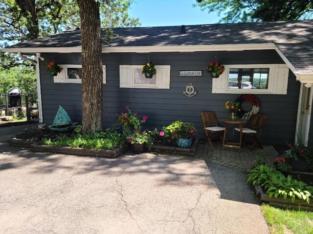 W5683 Park Rd, Elkhorn, WI 53121 - exterior space with a patio area and roof with shingles